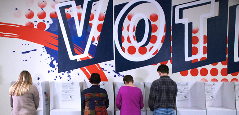 Individuals at voting booths in a polling location